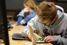 Computer and Information Science Student works on technology.